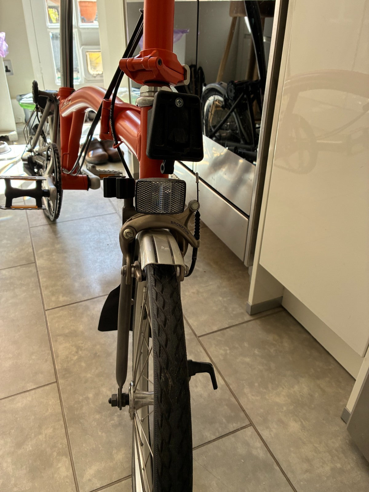 Brompton M3L Superlight Titanium  3 Speed in orange with front Ortlieb bag