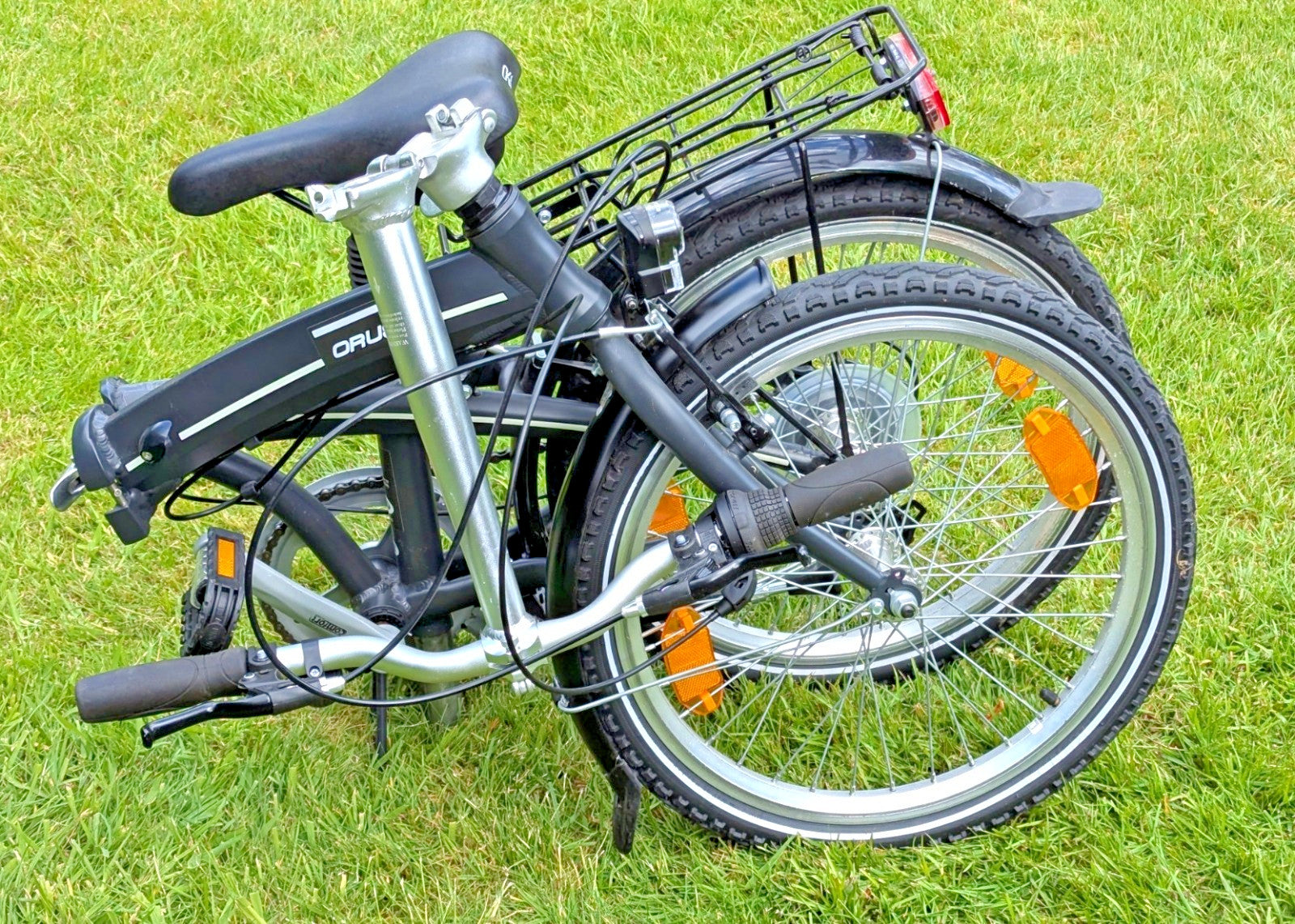 Folding Adult Bicycle with 7 speed Shimano gears, stand, lights, and pannier.