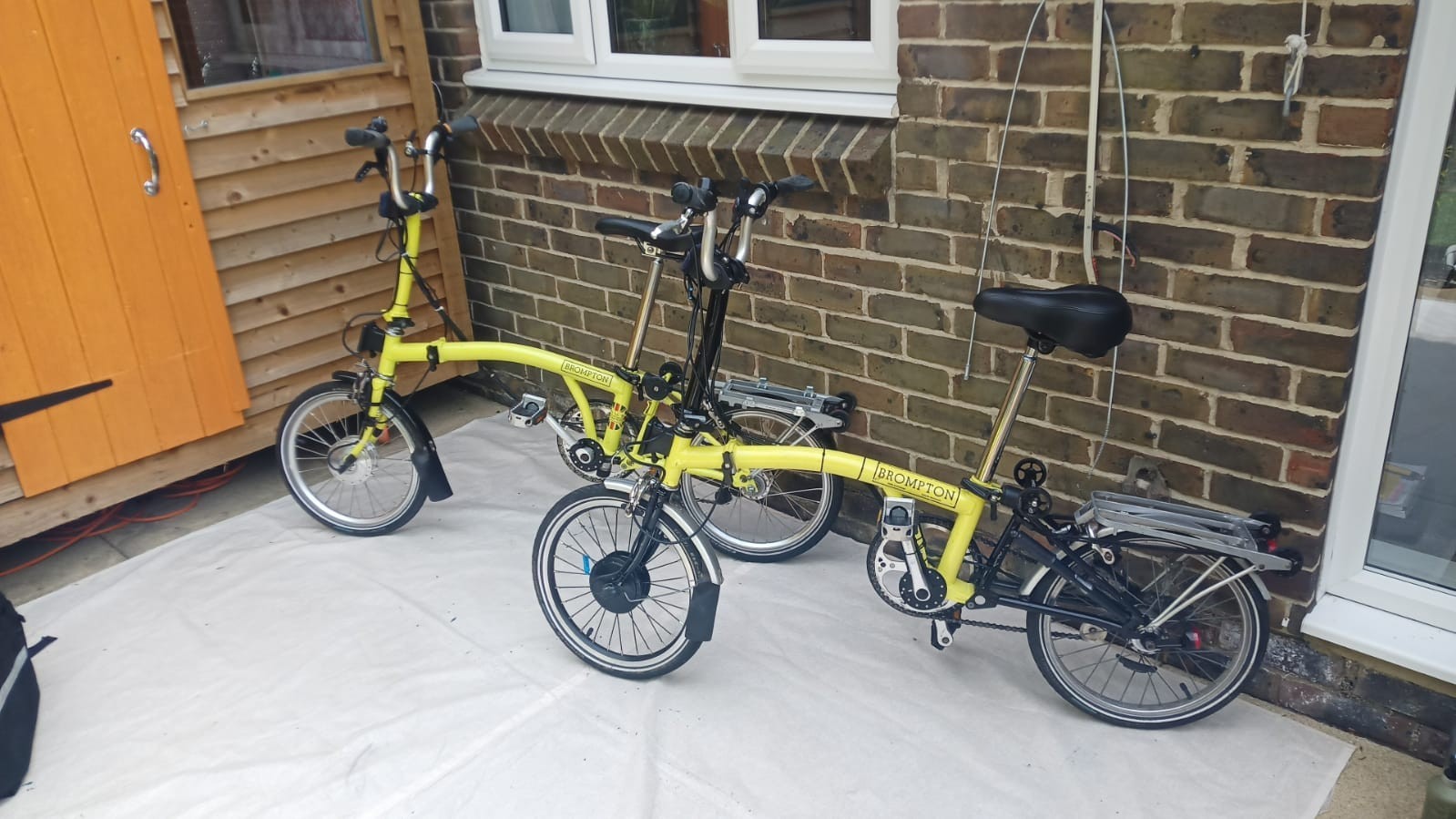 A Pair of Yellow Bromton Bikes In Excellent Condition with Conversion Kit