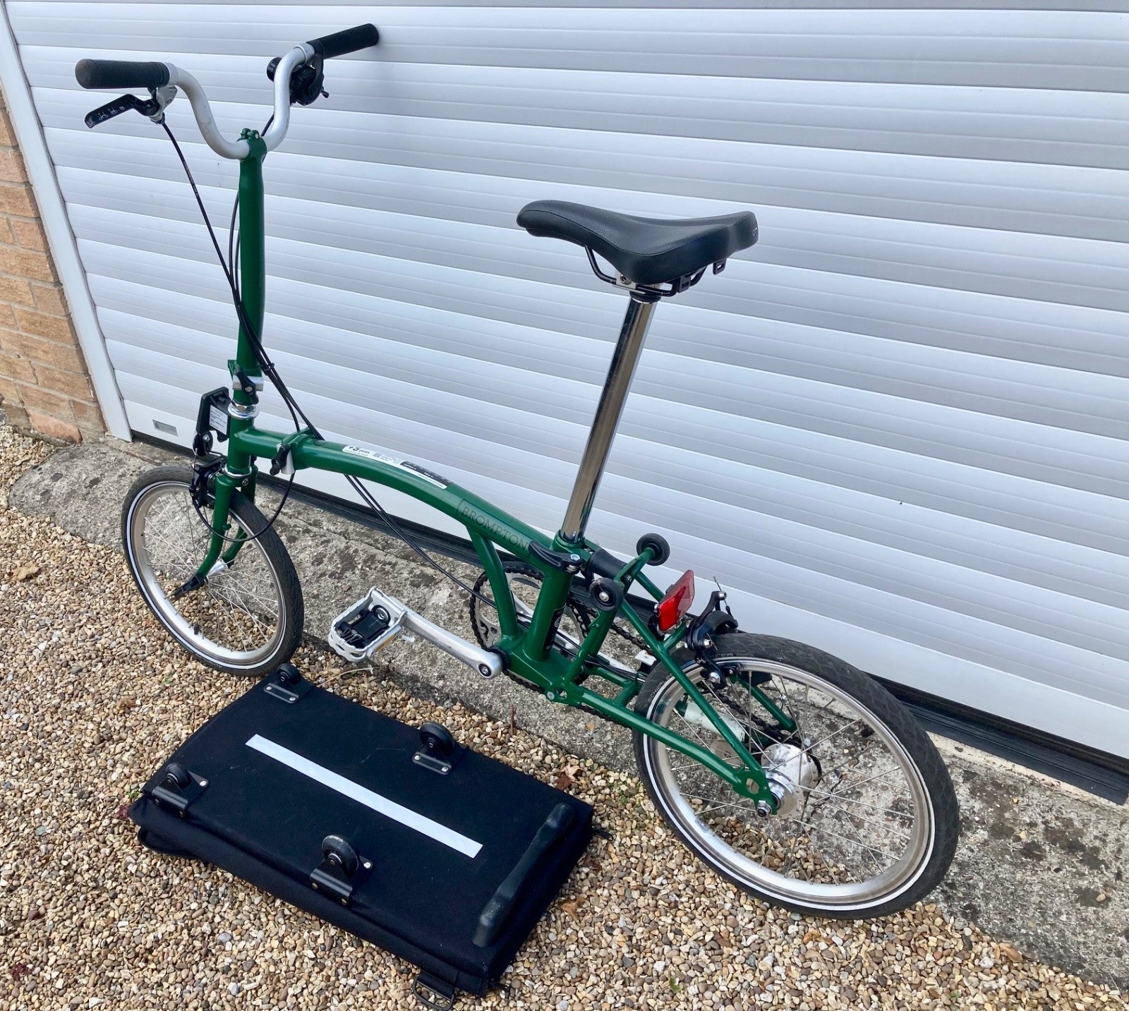 2023 Brompton C line folding bike, 3-speed, green,  with 4-roller transit bag