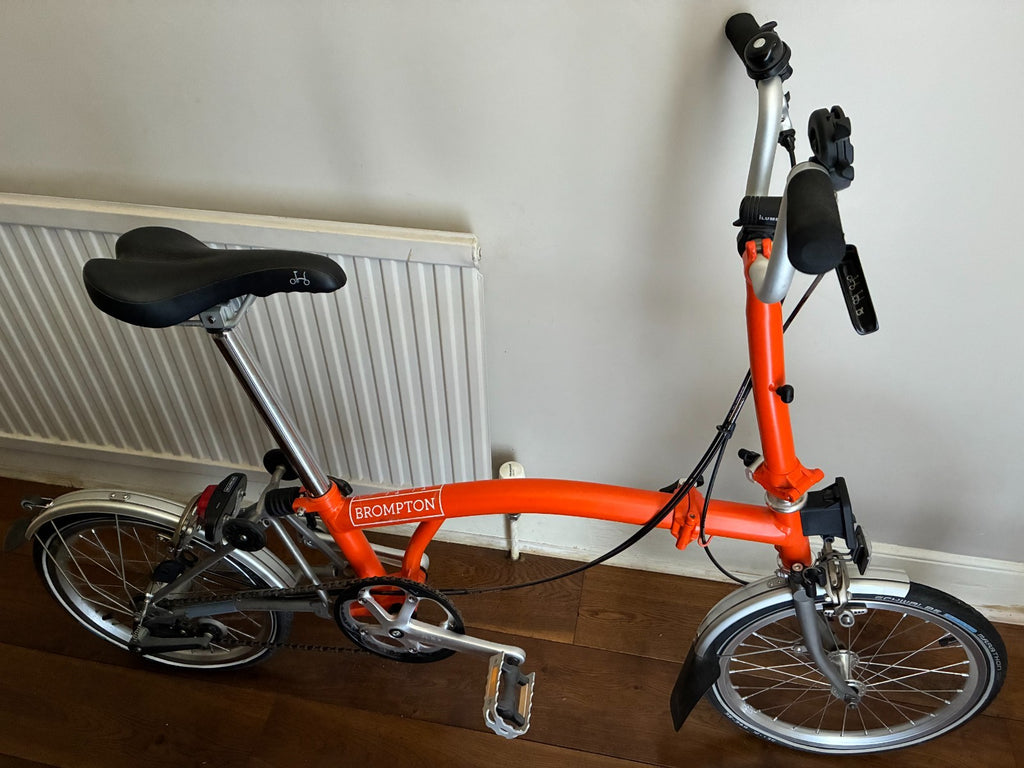 Brompton M3L Superlight Titanium  3 Speed in orange with front Ortlieb bag