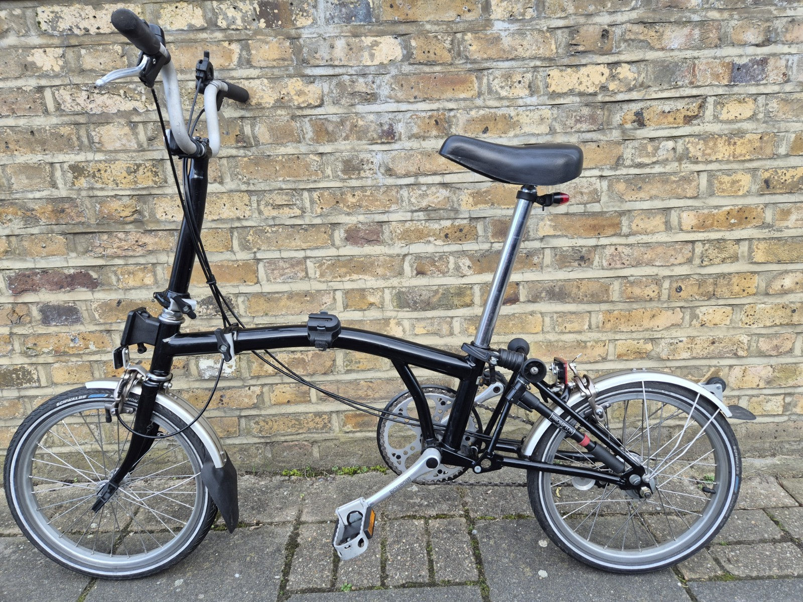 Brompton M3L folding bicycle in Satin Black with front bag.