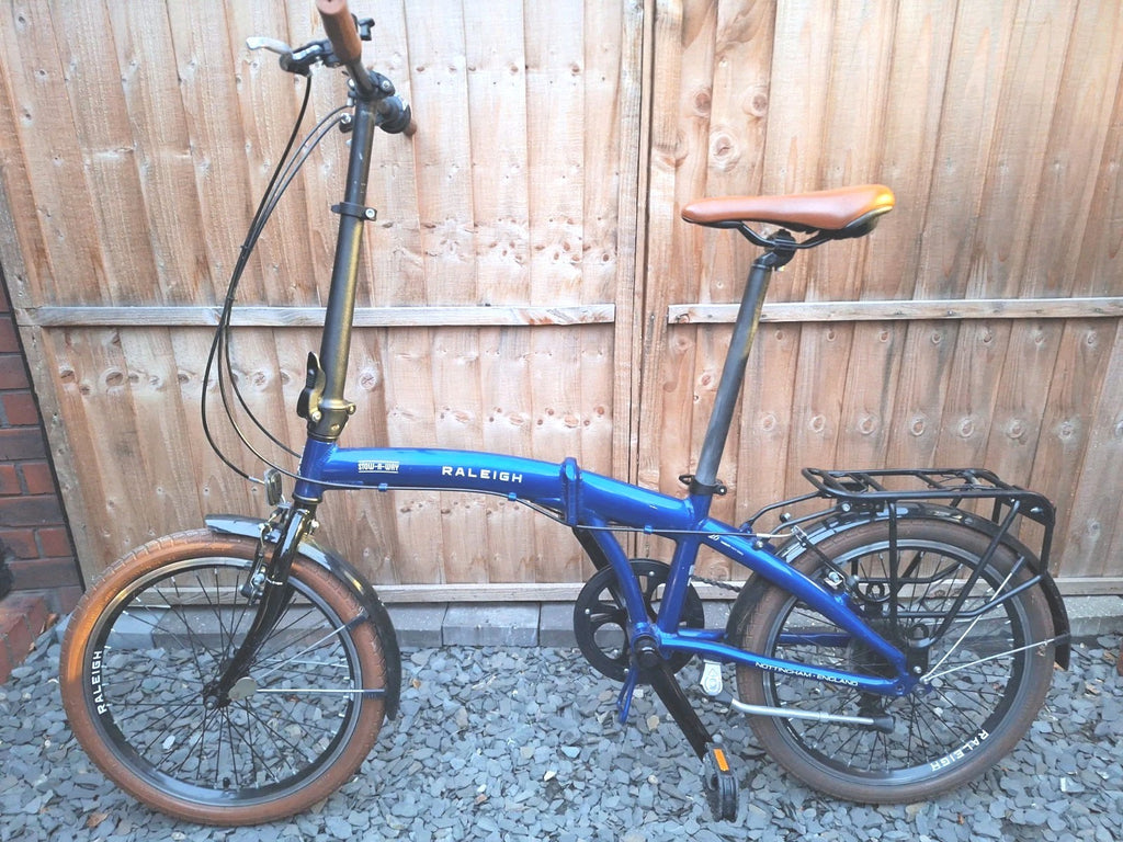 Raleigh Stowaway Folding Bike Unisex 7-Speed Hybrid Bicycle Blue  Mudgaurds Rack