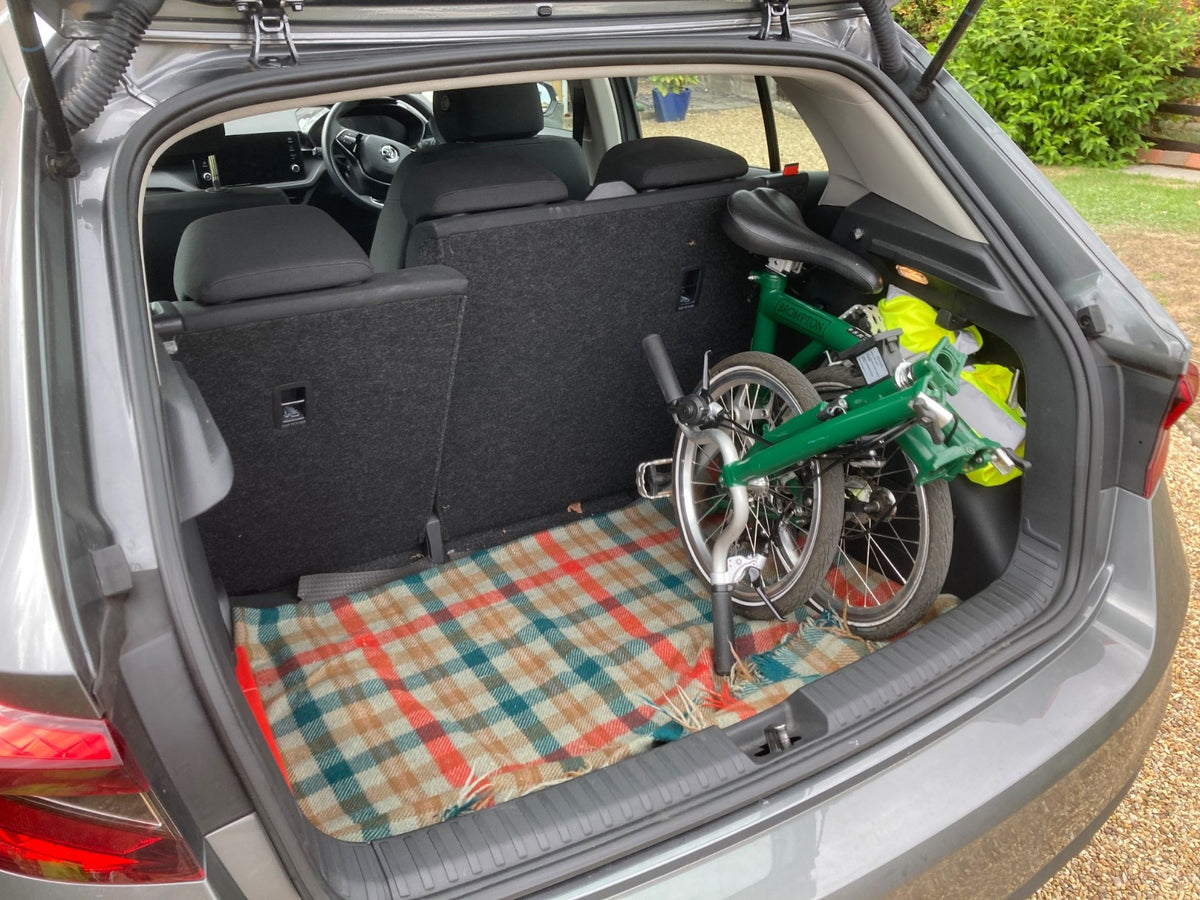 2023 Brompton C line folding bike, 3-speed, green,  with 4-roller transit bag