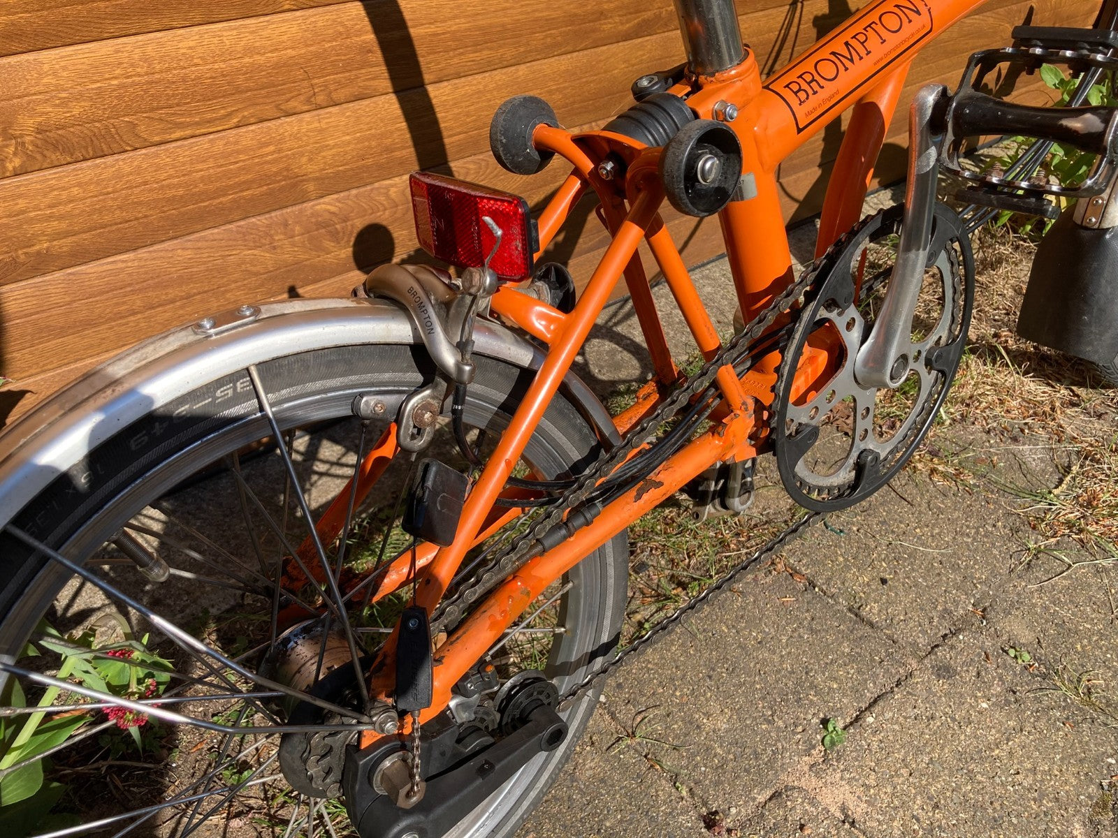 Classic Brompton 6-speed C-line folding bike in orange with long seatpost