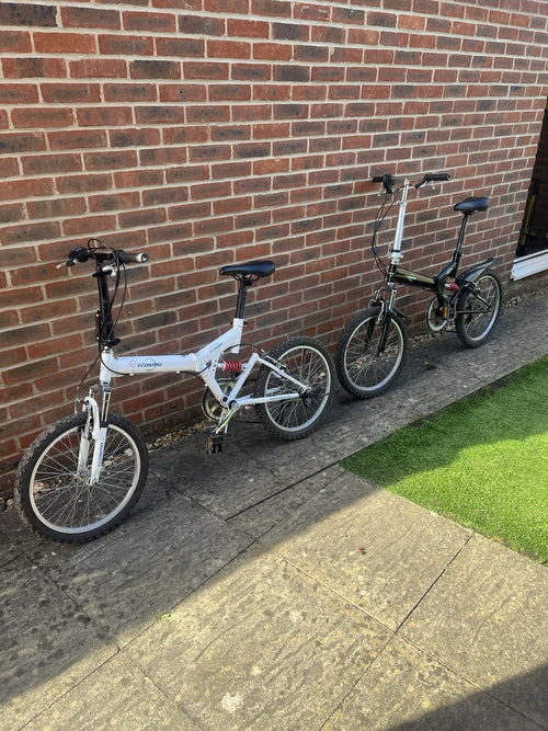 2 Folding Bikes 20 Inch Wheels One Black Or Me White With Adjustable Suspension