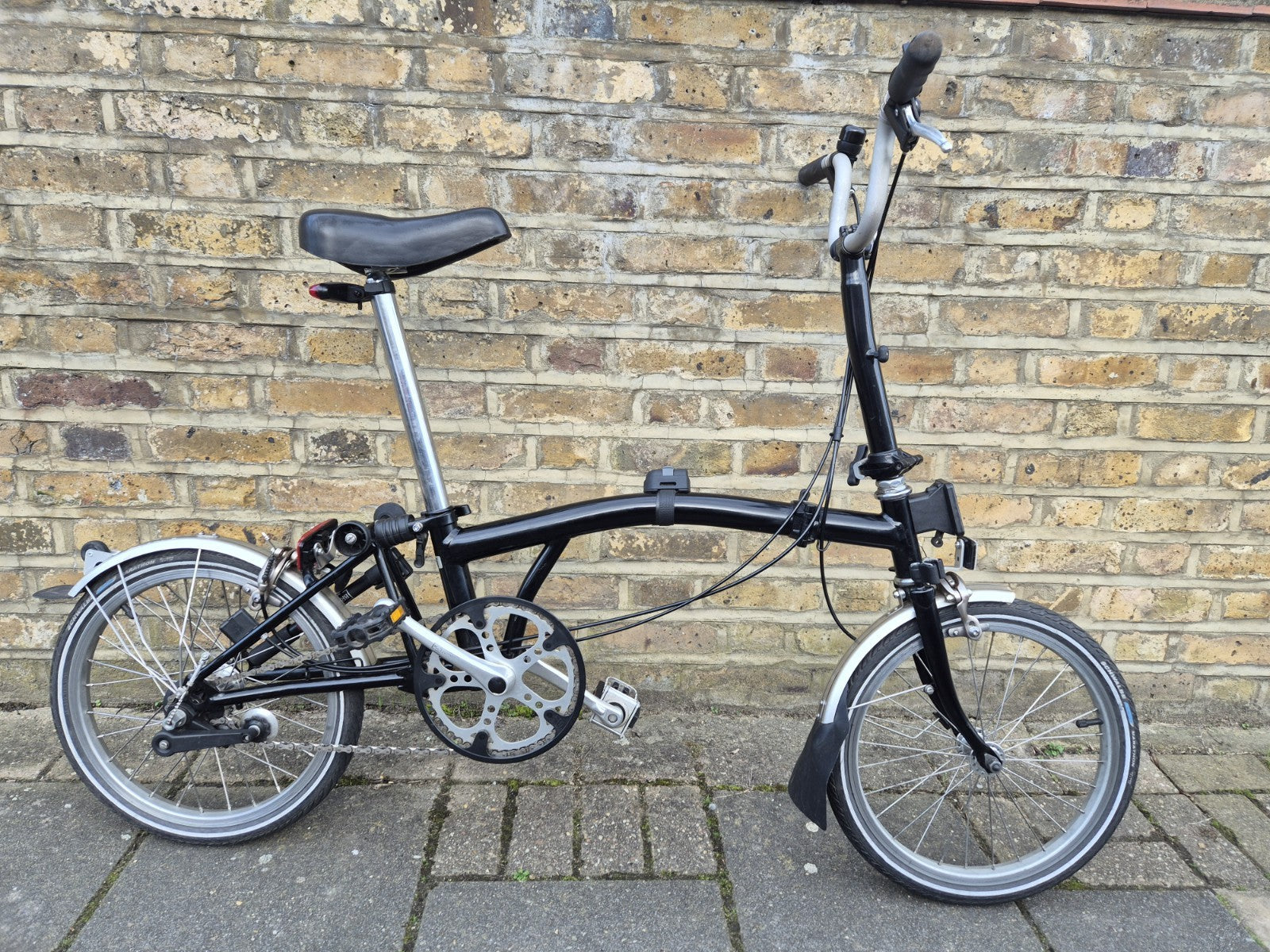 Brompton M3L folding bicycle in Satin Black with front bag.
