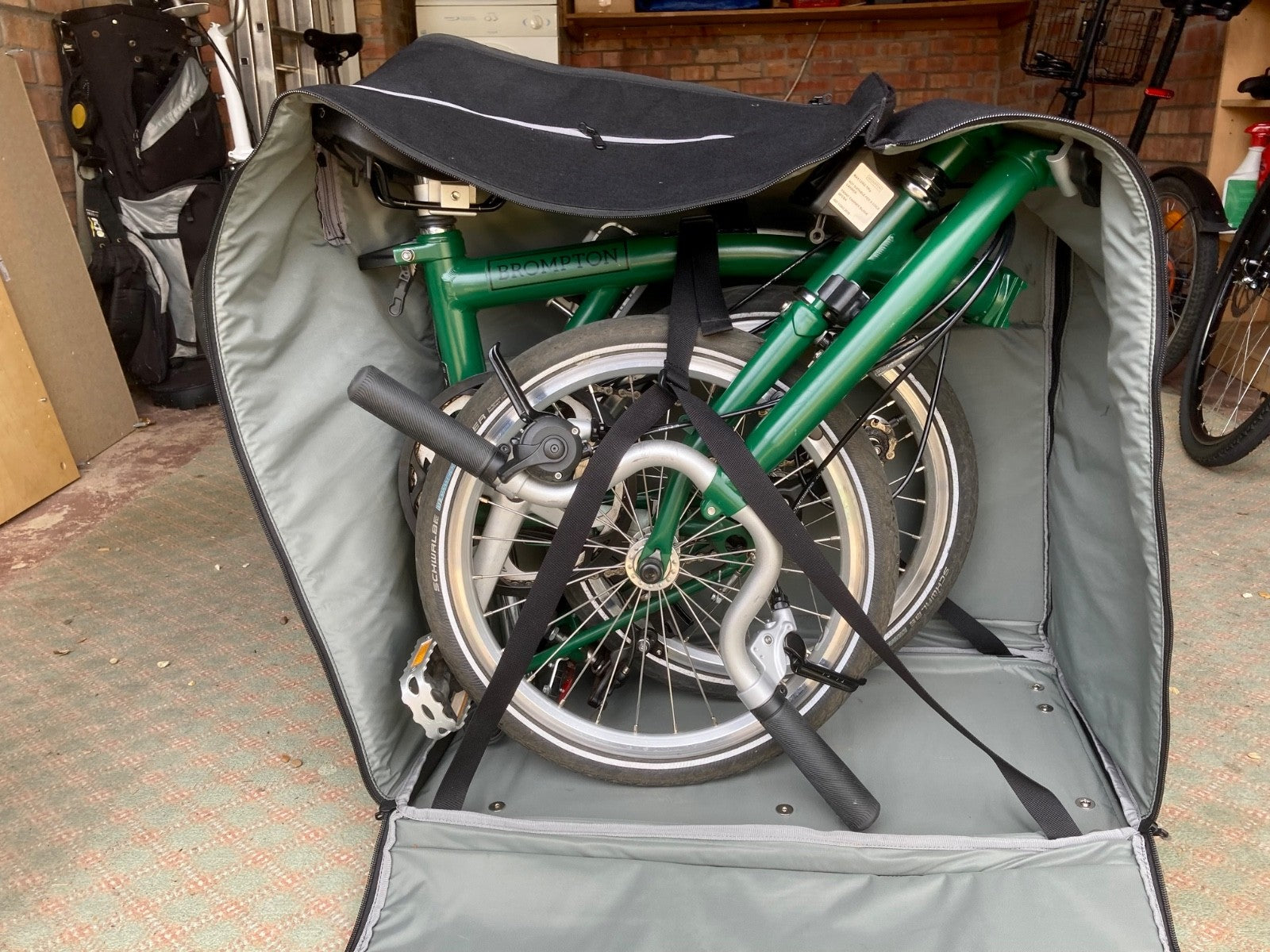 2023 Brompton C line folding bike, 3-speed, green,  with 4-roller transit bag