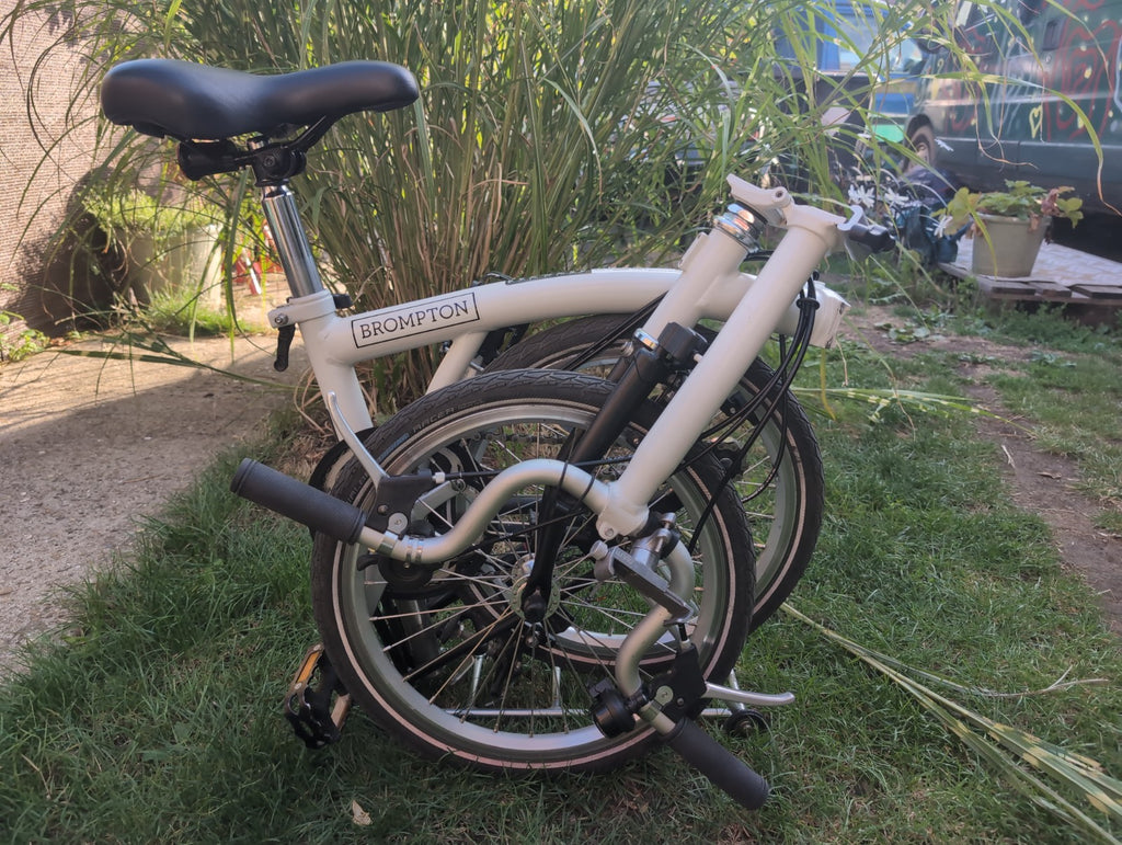 Brompton A line folding bike with led lights and wheel rack.