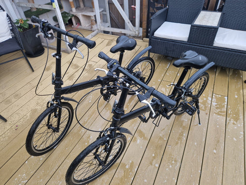 2x Black Folding Bikes w/ Mudguards, V-Brakes, Flat Bar, Grip Shifter