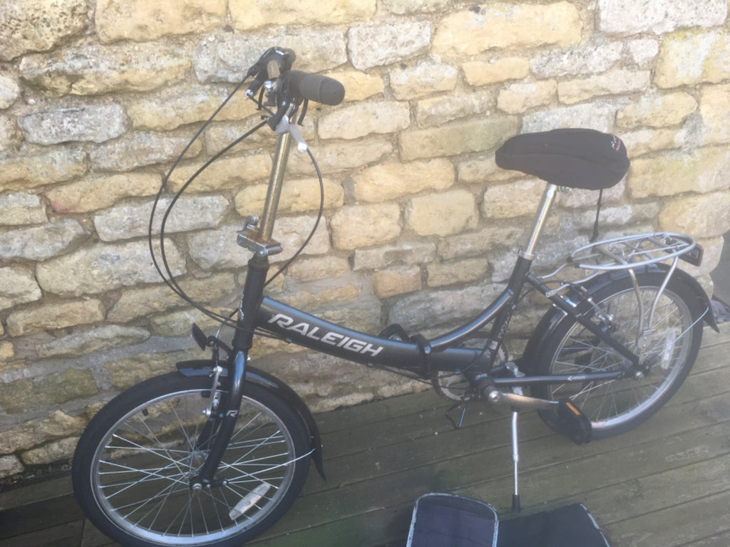 Raleigh Folding Bike plus cover.  Good condition