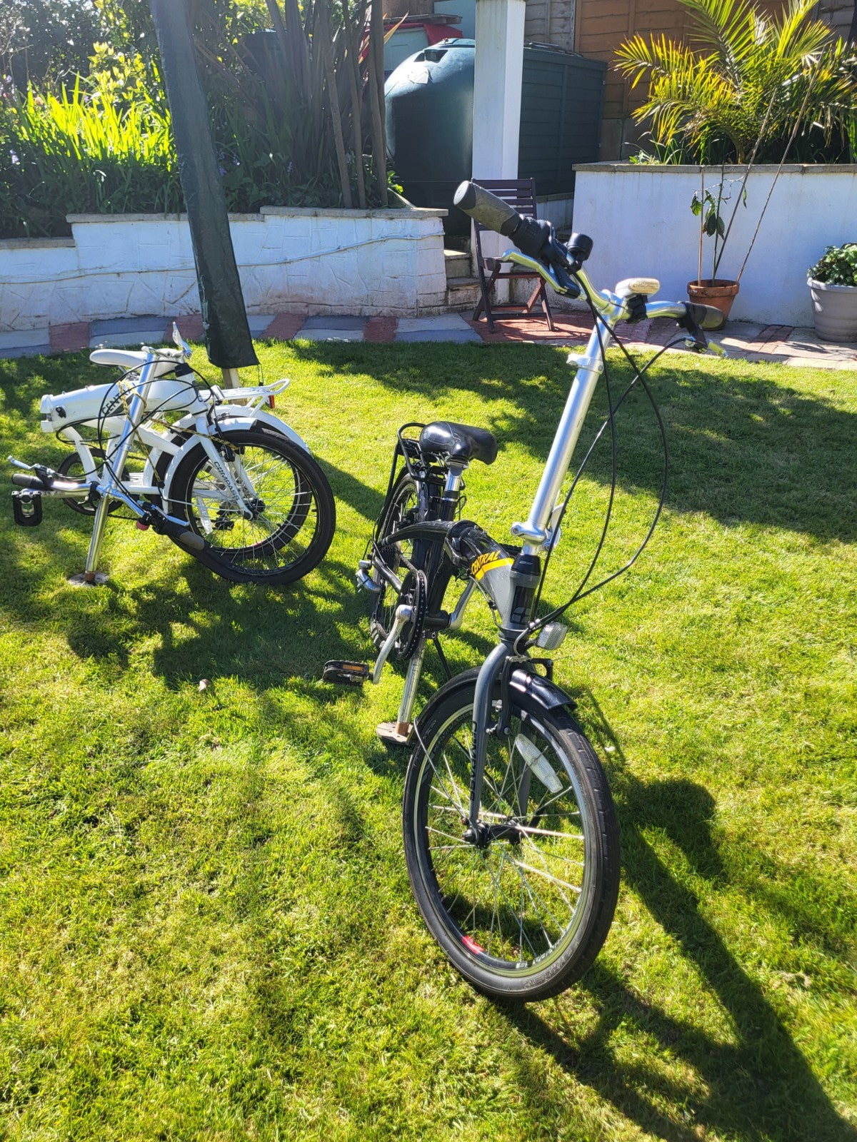 Compass Central  20in Folding Bicycles X  2, one white, one black.