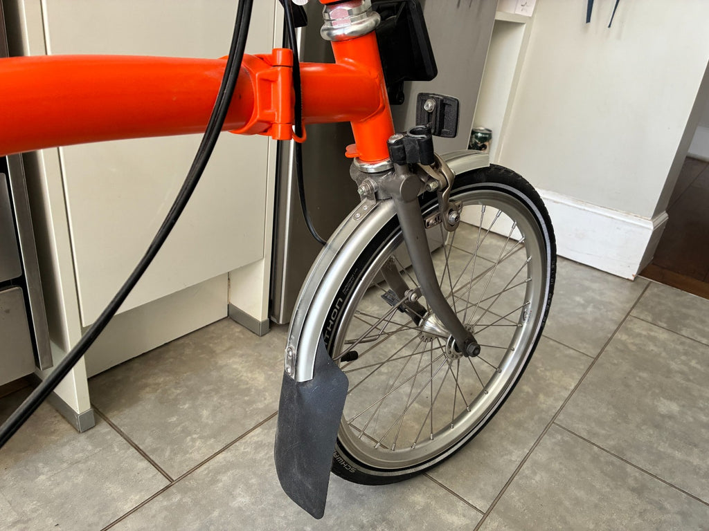 Brompton M3L Superlight Titanium  3 Speed in orange with front Ortlieb bag