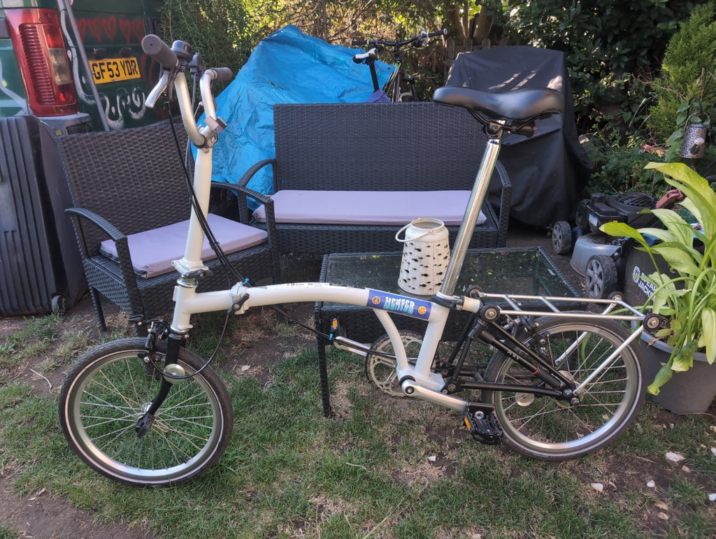 Brompton A line folding bike with led lights and wheel rack.