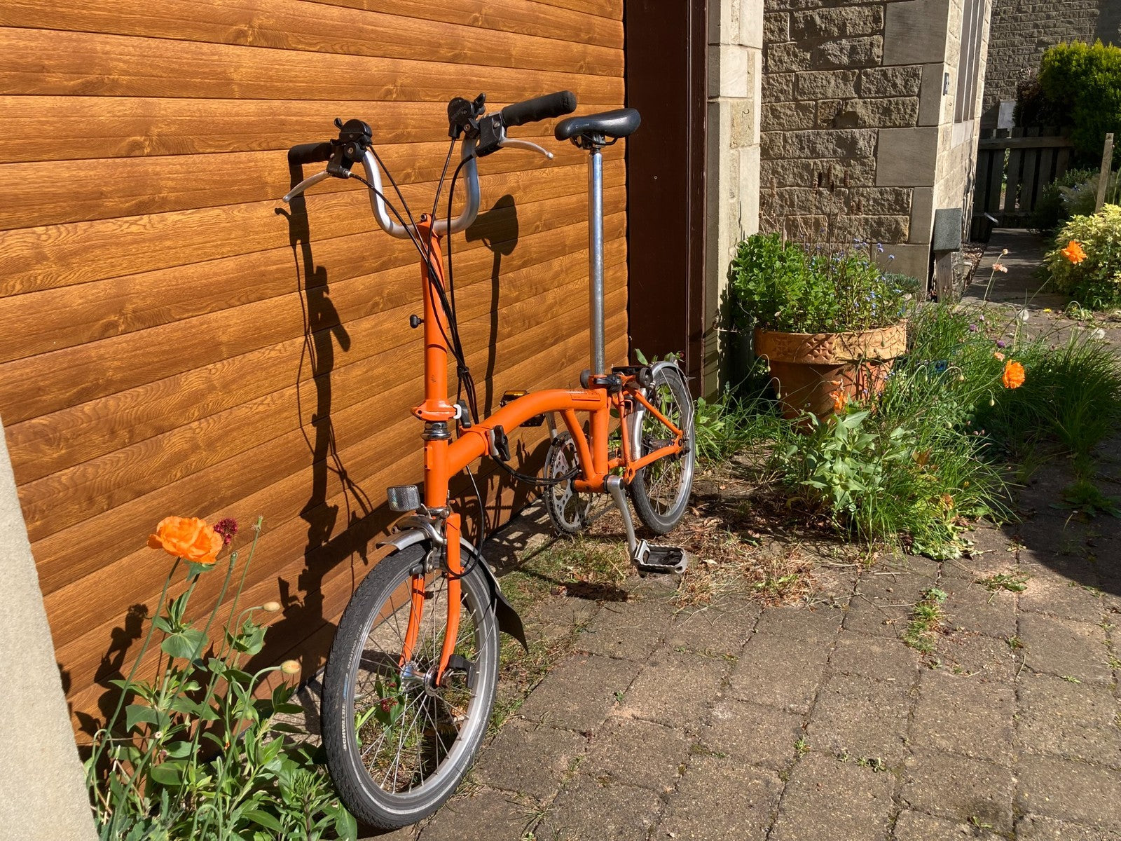 Classic Brompton 6-speed C-line folding bike in orange with long seatpost