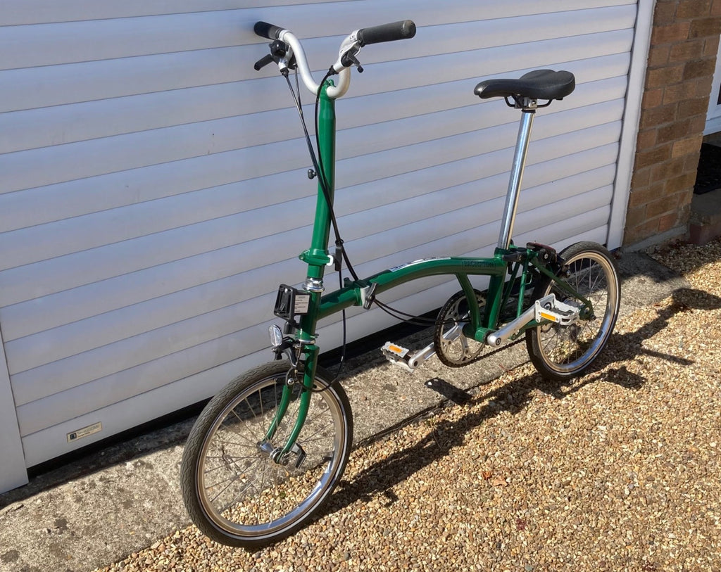 2023 Brompton C line folding bike, 3-speed, green,  with 4-roller transit bag