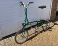 2023 Brompton C line folding bike, 3-speed, green,  with 4-roller transit bag