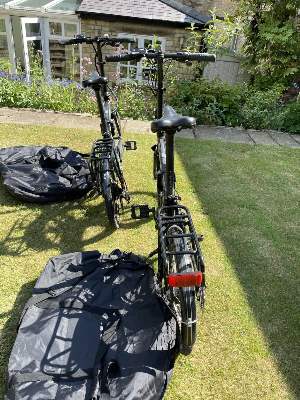 2 X Carrera Crossfire Folding Bikes With Storage Bags.