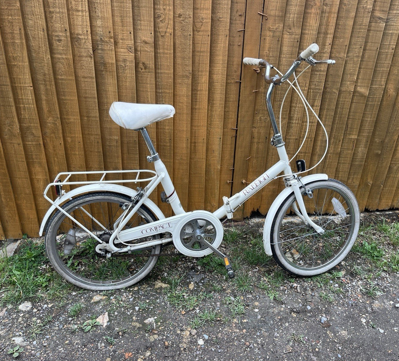 Raleigh Folding Bike White 1 Rack.  Carrera Crossfire 2 and one other bike.