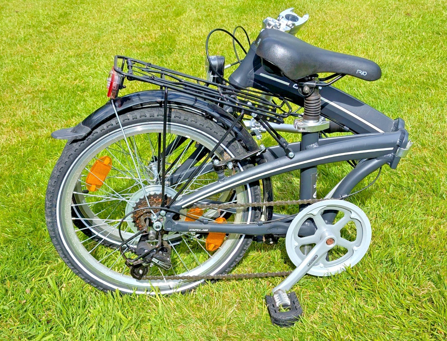 Folding Adult Bicycle with 7 speed Shimano gears, stand, lights, and pannier.