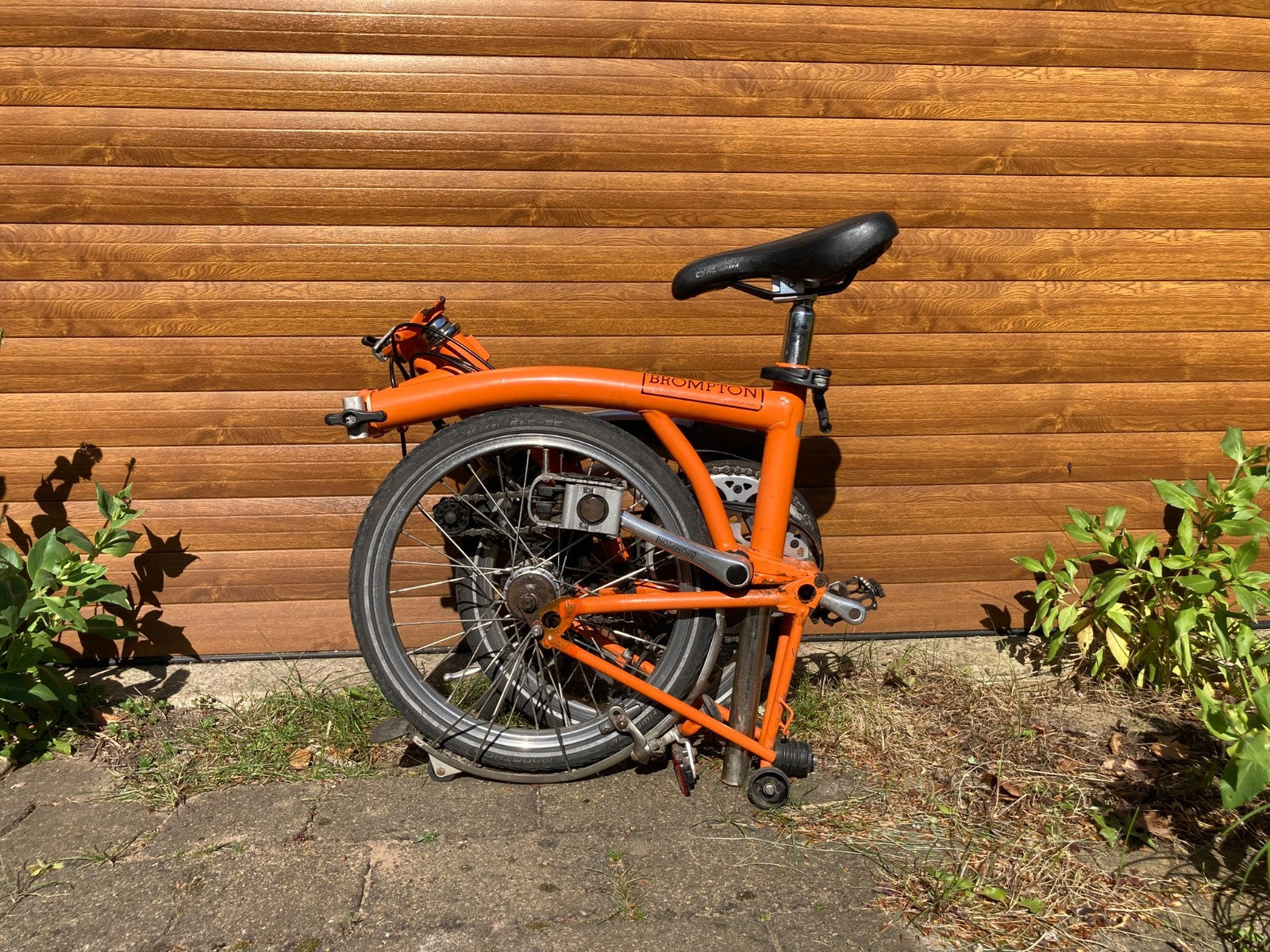 Classic Brompton 6-speed C-line folding bike in orange with long seatpost