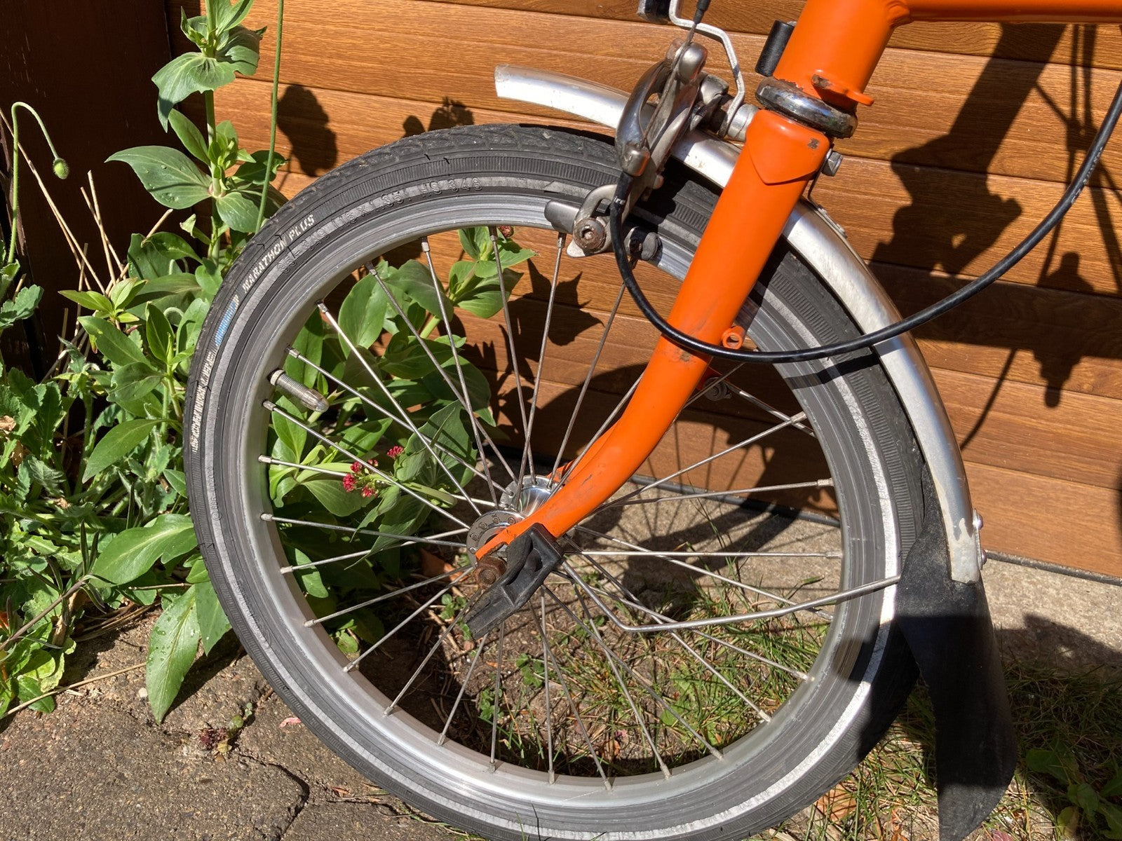 Classic Brompton 6-speed C-line folding bike in orange with long seatpost