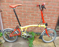 Brompton 3-Speed Red & Yellow Folding Bike + Front Travel Bag ('T-Bag')