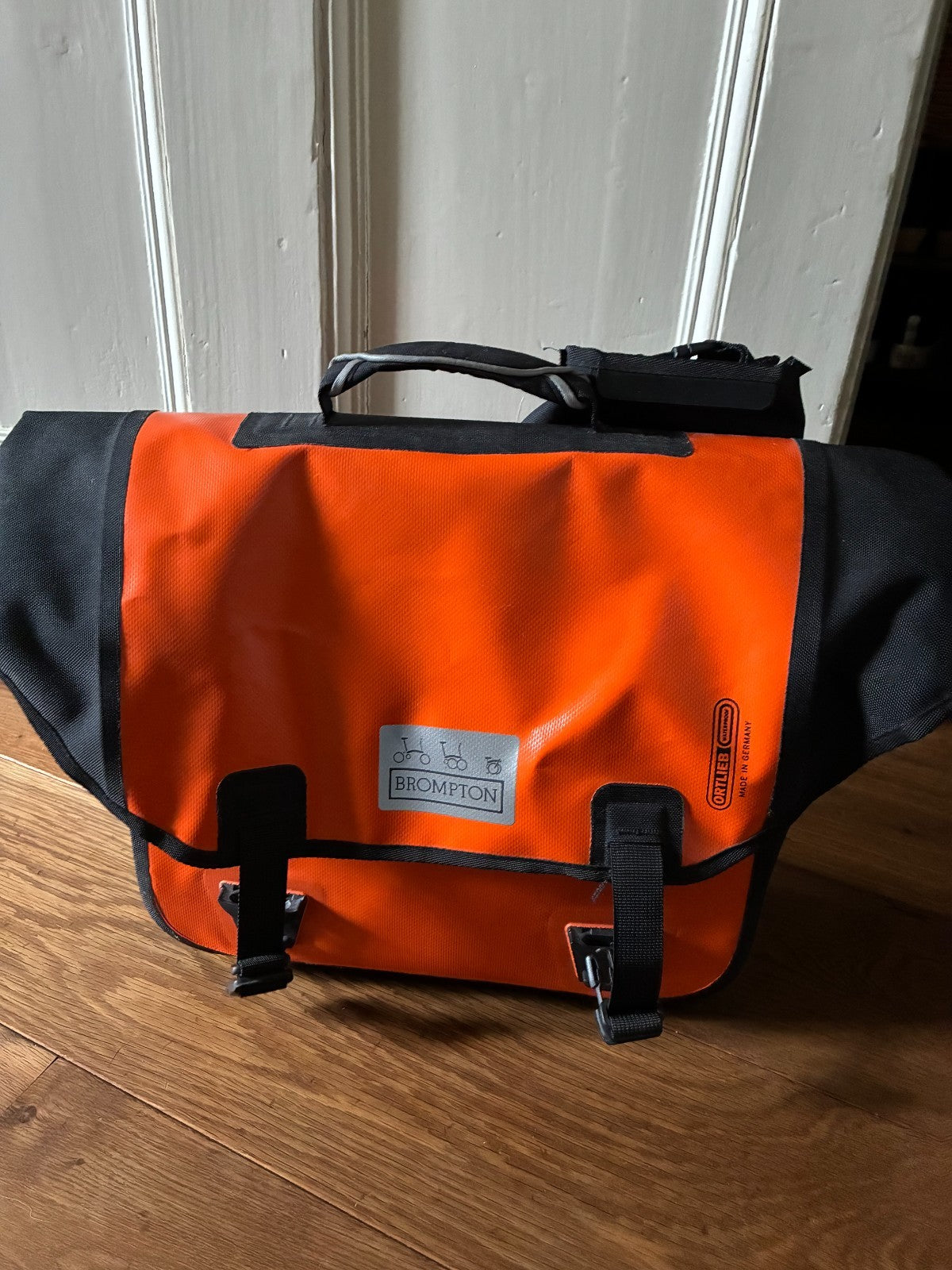 Brompton M3L Superlight Titanium  3 Speed in orange with front Ortlieb bag