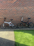2 Folding Bikes 20 Inch Wheels One Black Or Me White With Adjustable Suspension