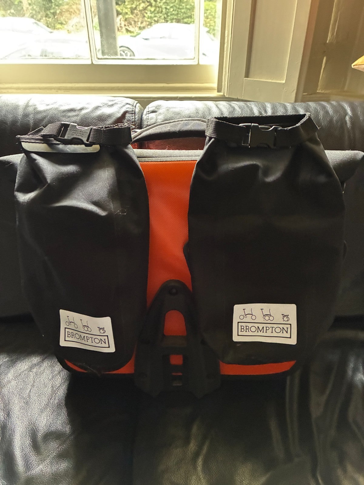 Brompton M3L Superlight Titanium  3 Speed in orange with front Ortlieb bag