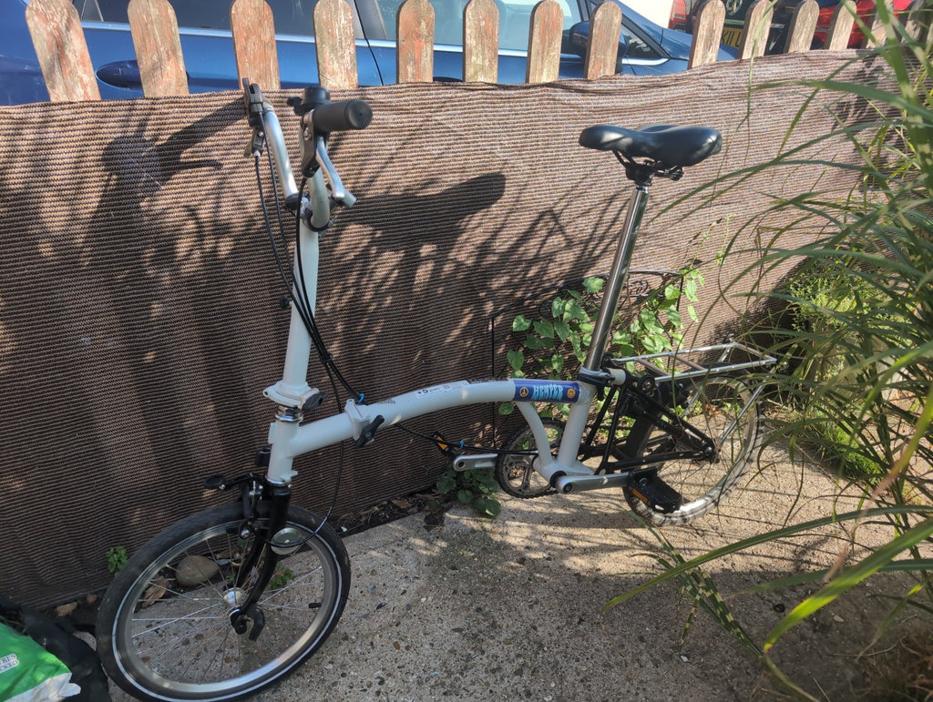 Brompton A line folding bike with led lights and wheel rack.