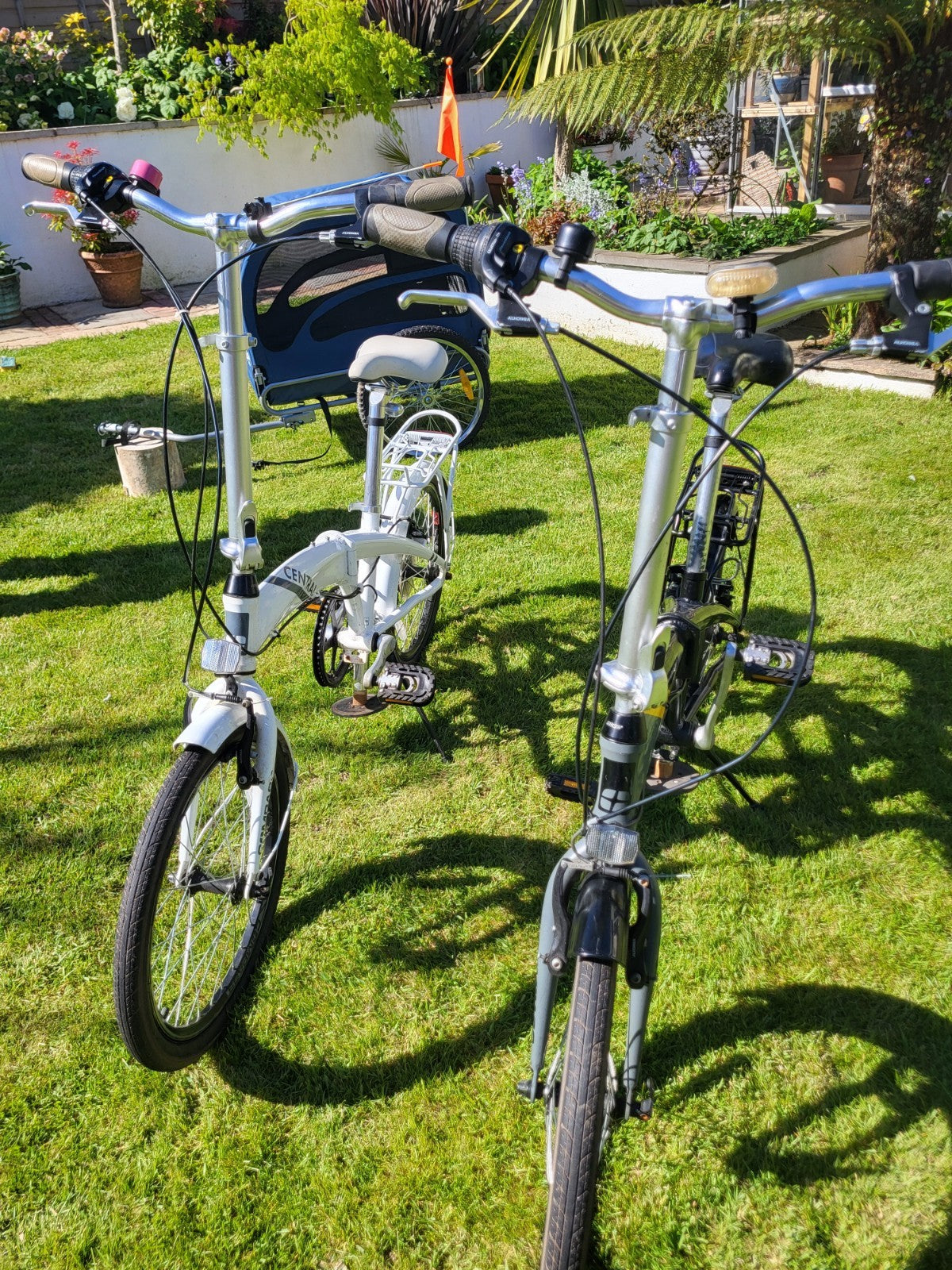 Compass Central  20in Folding Bicycles X  2, one white, one black.