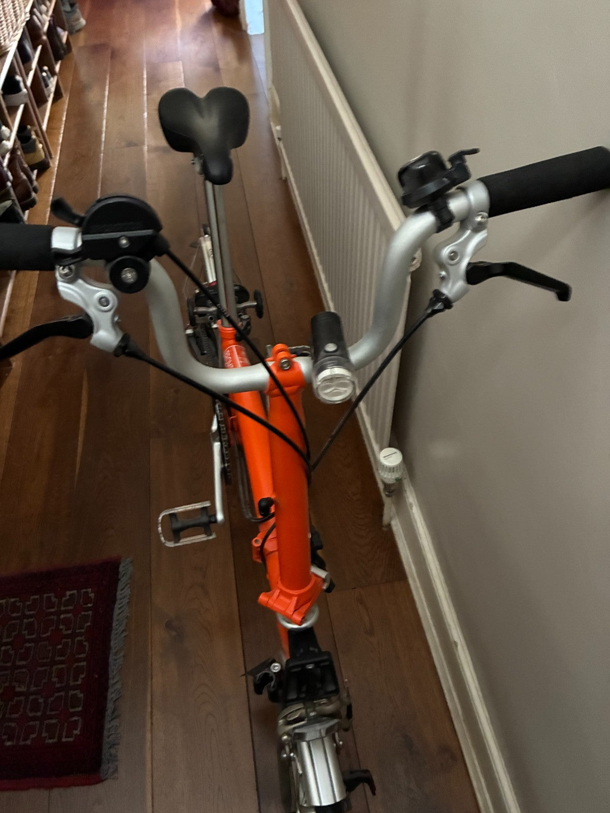 Brompton M3L Superlight Titanium  3 Speed in orange with front Ortlieb bag