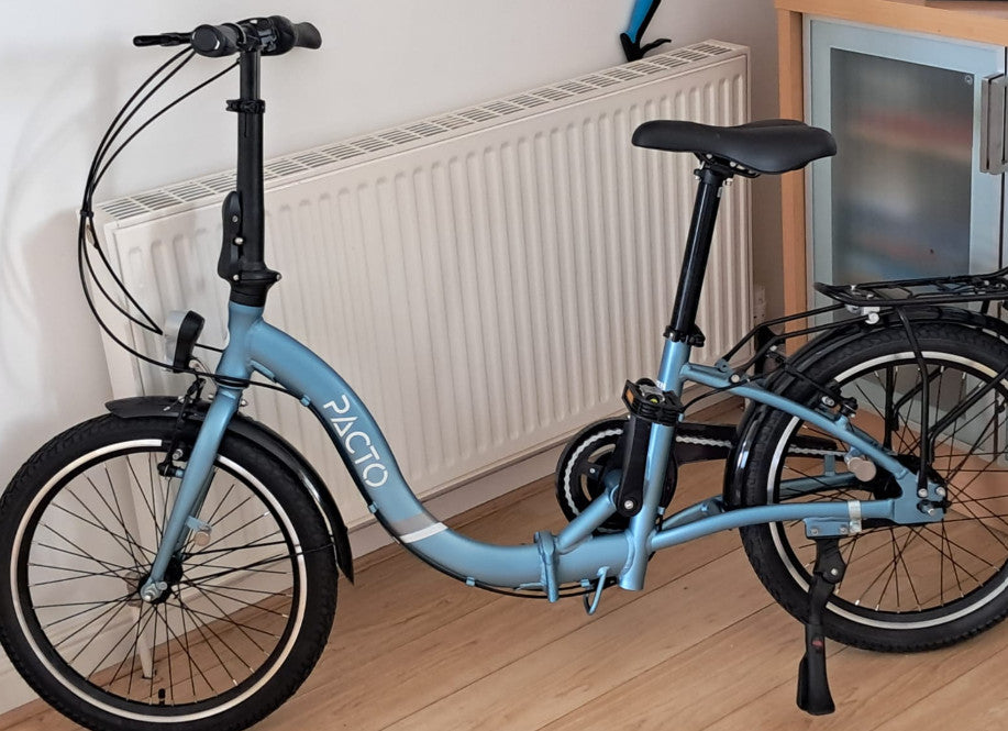 Blue PACTO folding bike .. 20 inch wheels and 7 speed hub gears.