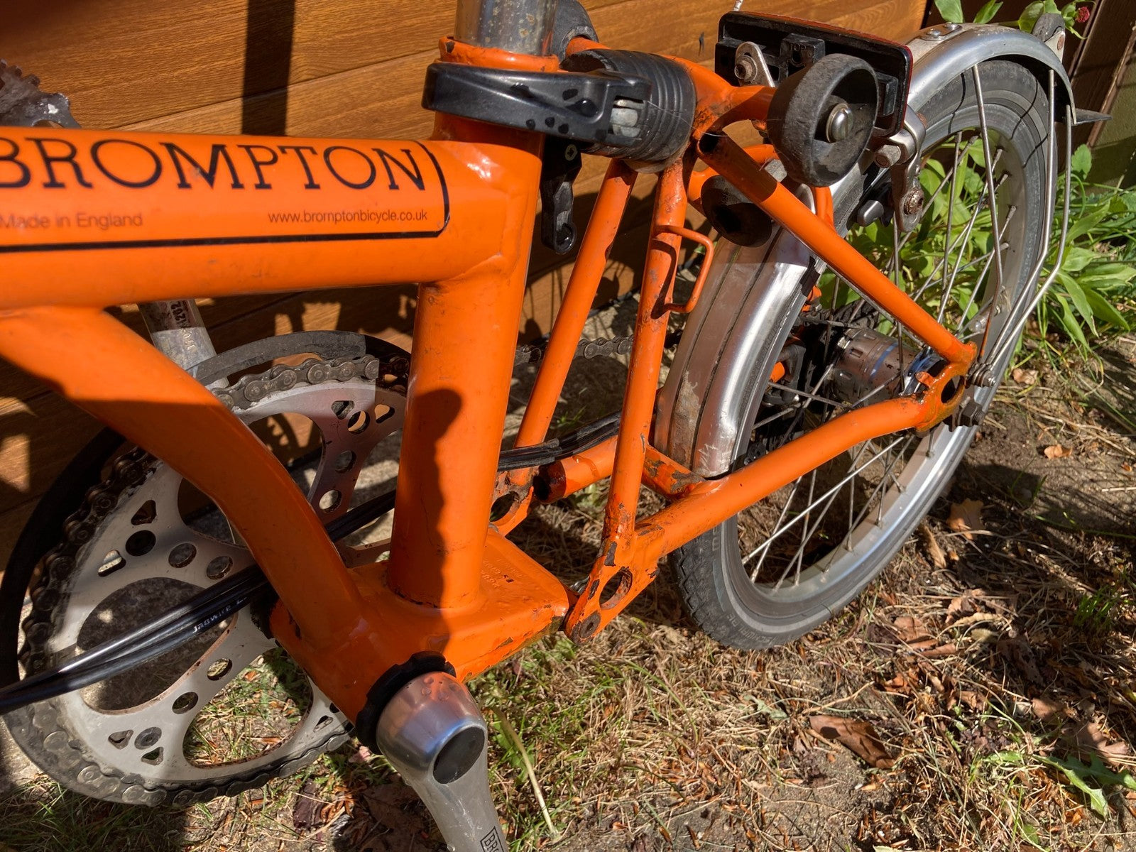 Classic Brompton 6-speed C-line folding bike in orange with long seatpost