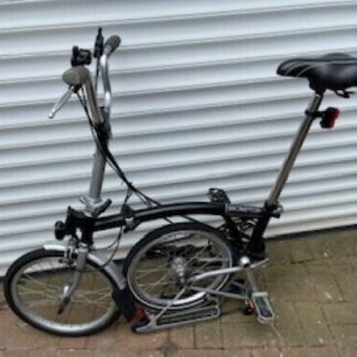Brompton folding bike 6 speed, black with front mounted bag and dynamo lights